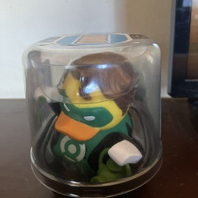 Figurine in a clear display case on a wooden surface