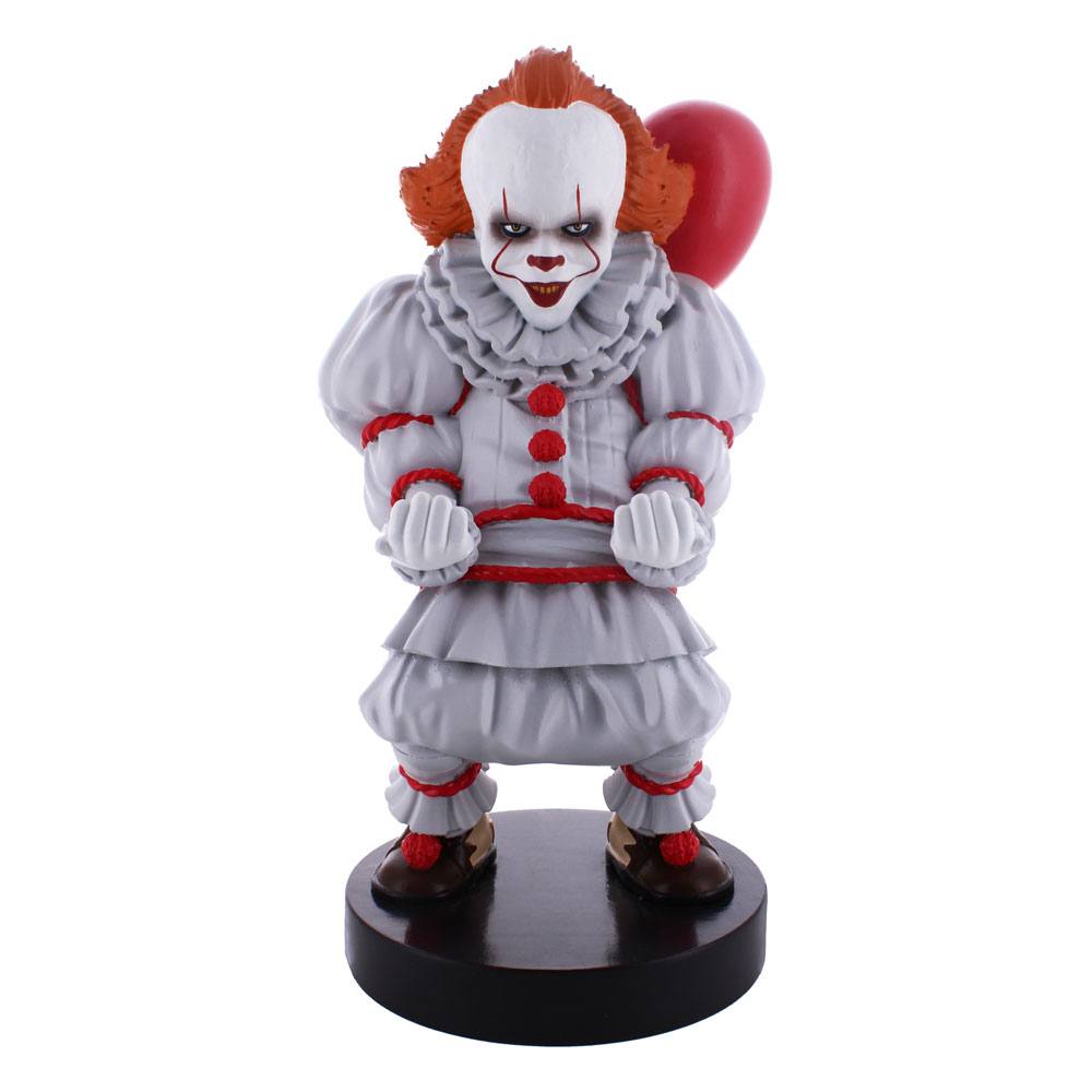 Clown figurine with red hair and white face on a black base against a white background