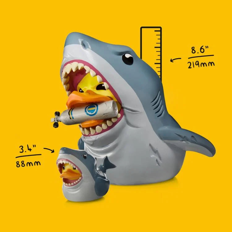 Shark-shaped toy with a duck inside, showing measurements on a yellow background