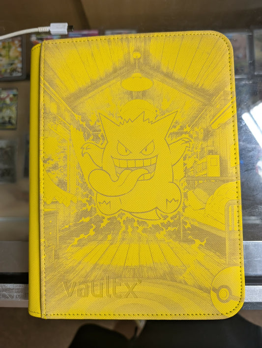 Yellow Pokémon trading card holder with character design on a blurred background