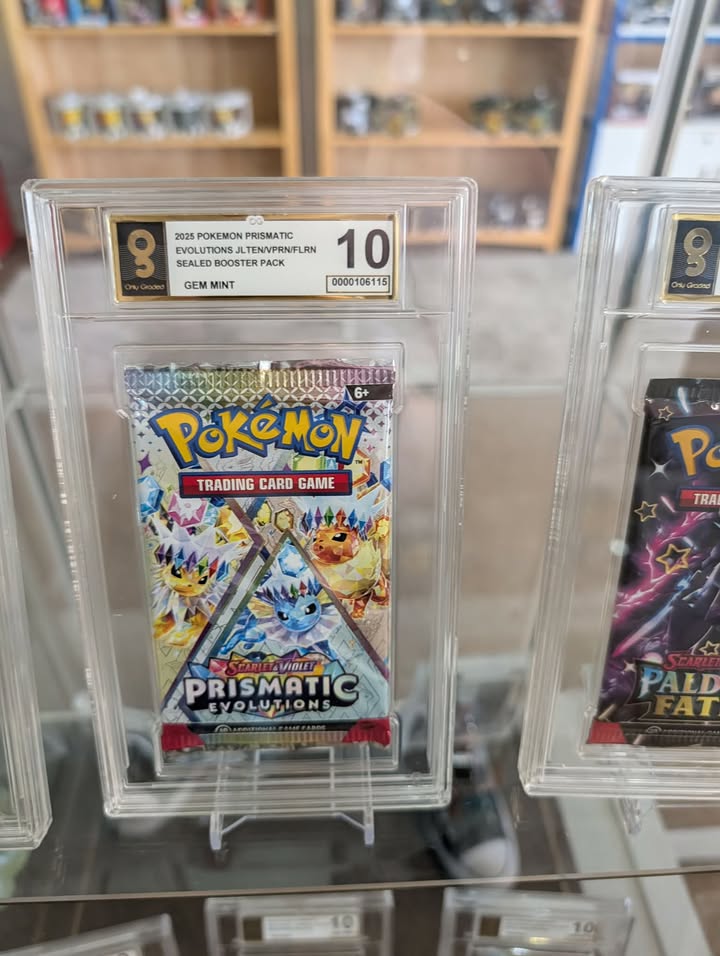Pokémon trading card game packs in protective cases with grading labels.