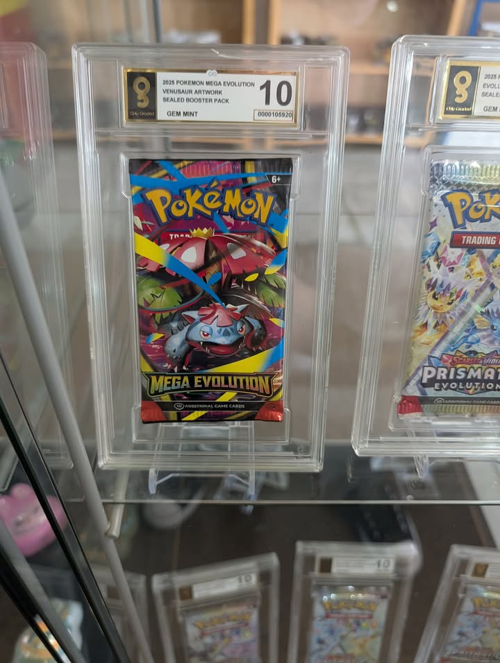 Pokémon trading card packs in protective cases with grading labels.