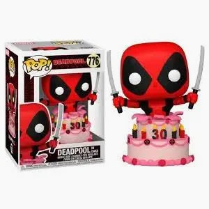 Deadpool figurine with birthday cake and candles on a white background