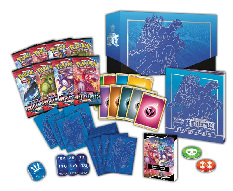 Pokémon trading card game set with cards, a player's guide, and dice on a white background