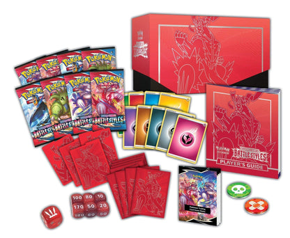Pokémon trading card game set with cards, guidebook, and dice on a white background