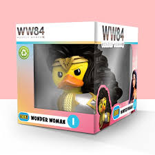 Toy figure in packaging with 'WW84' branding on a pink background