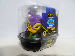 Toy figure of a superhero in a clear container with visible branding.