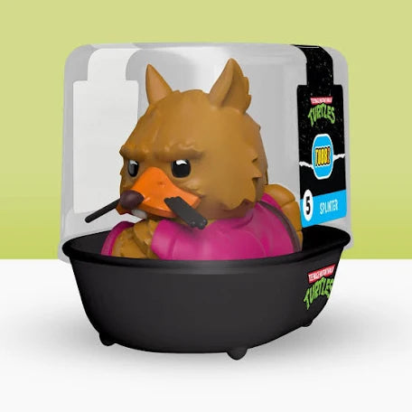 Toy figure of a character with a duck head and turtle body in packaging on a light green background