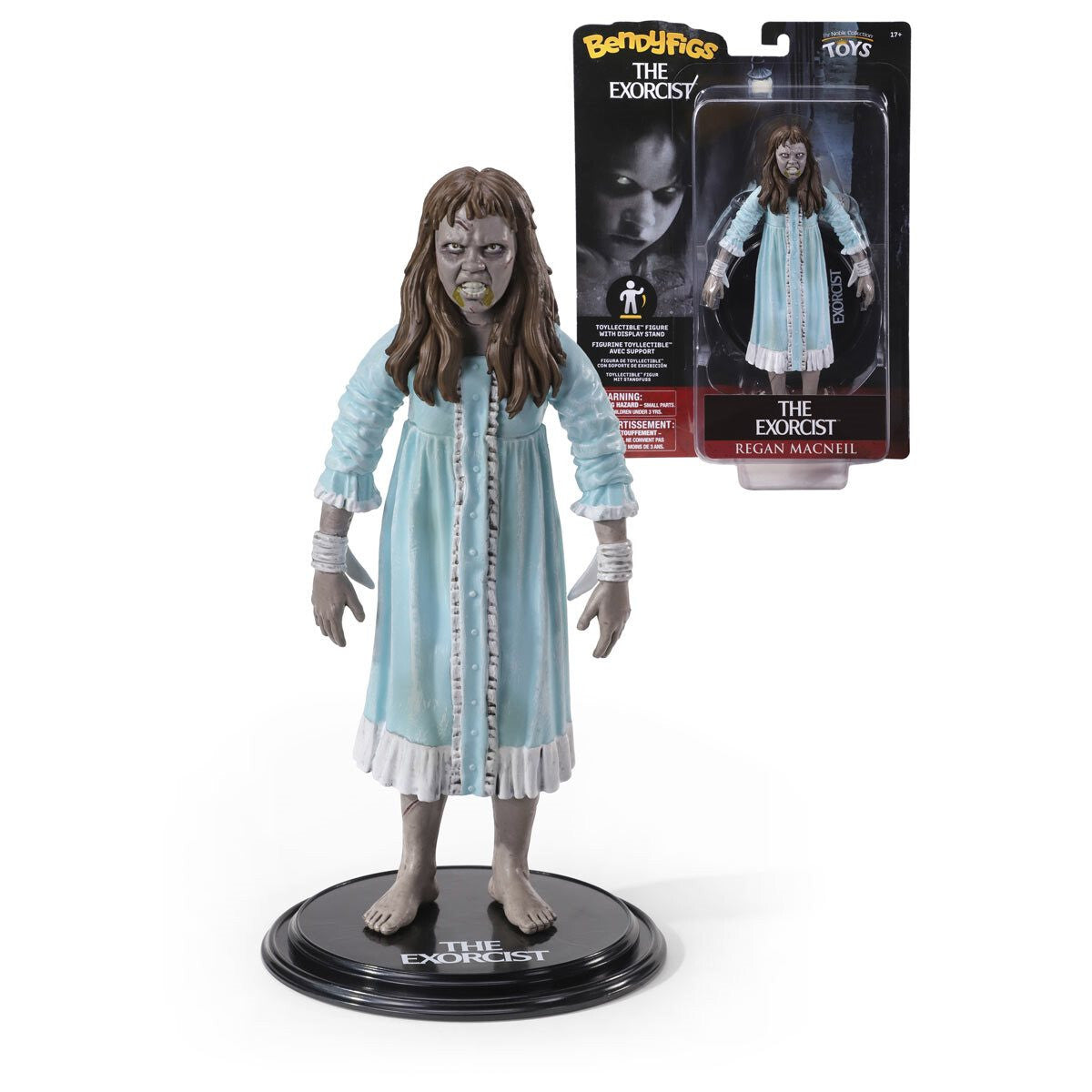 Action figure of Regan from 'The Exorcist' with packaging in the background