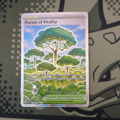 Pokémon trading card titled 'Forest of Vitality' on a textured surface