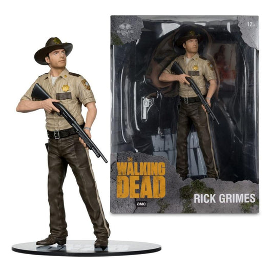 Action figure of Rick Grimes from 'The Walking Dead' with packaging in the background